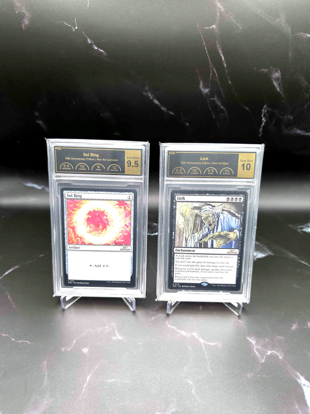 PCG-graded Magic: The Gathering 30th Anniversary Sol Ring and Lich cards