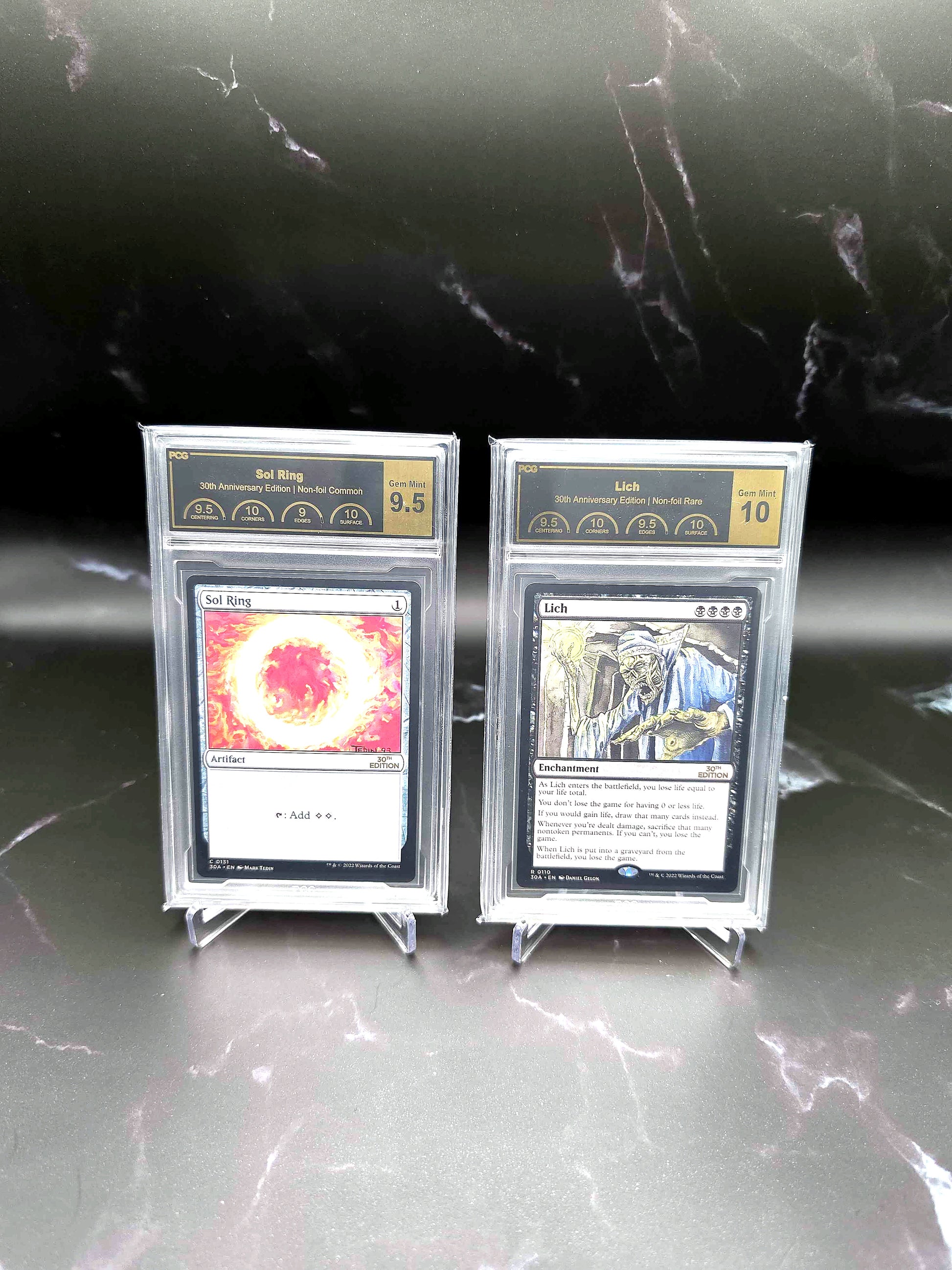 PCG-graded Magic: The Gathering 30th Anniversary Sol Ring and Lich cards