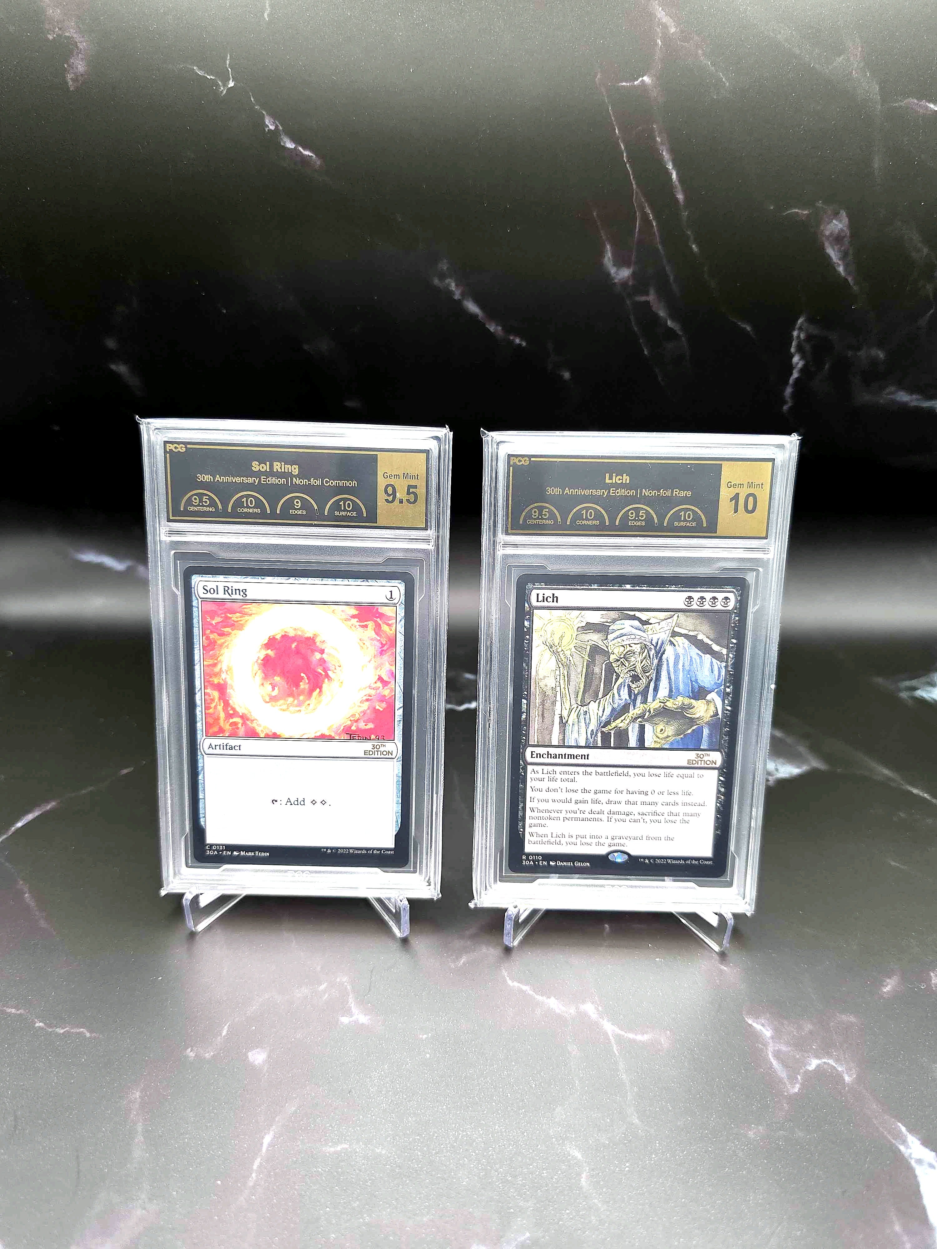 PCG-graded Magic: The Gathering 30th Anniversary Sol Ring and Lich cards